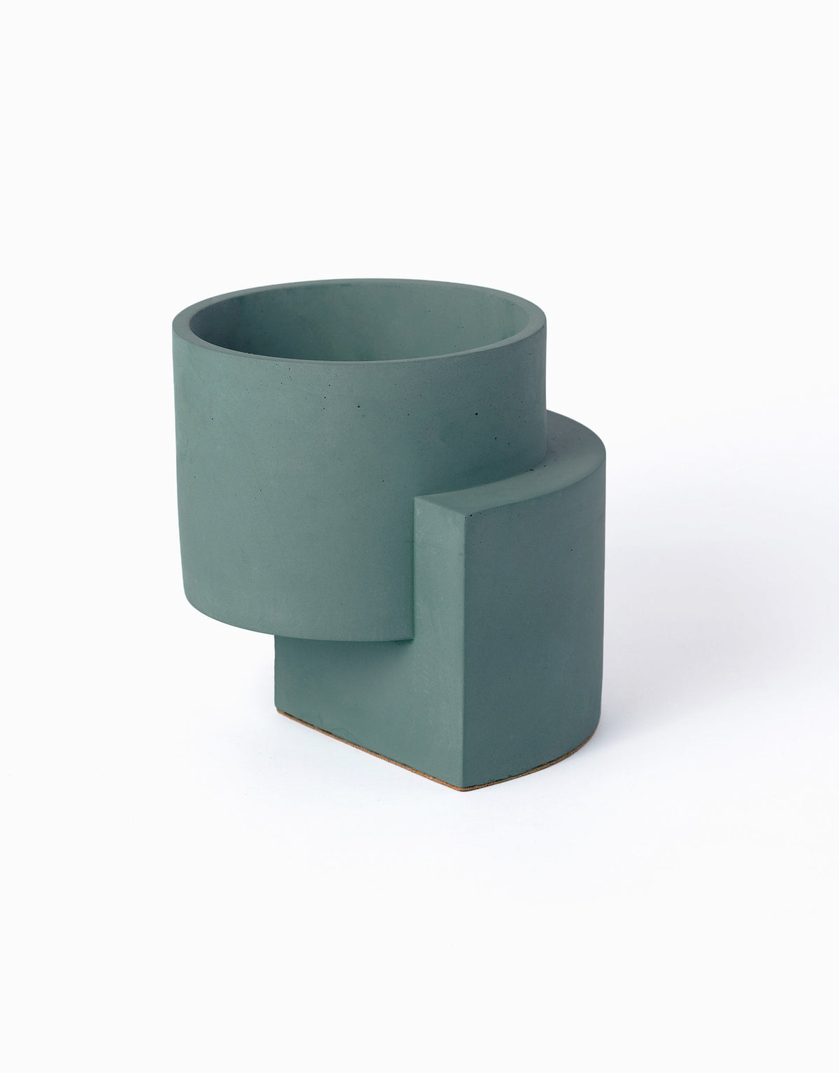 Blue-green Tortuga Forma Platform Planter Medium - Polished Concrete viewed at an angle on white, showing its circular opening, cylindrical bowl and offset curved support extending beneath it.