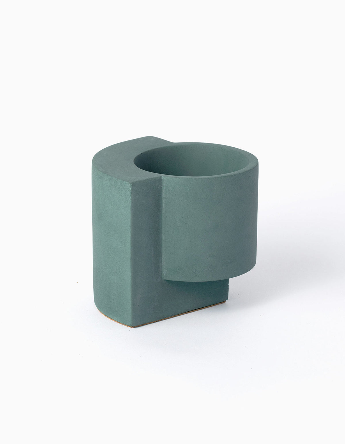 Dark blue-green Tortuga Forma Platform Planter Small - Polished Concrete on white, viewed slightly from above to show its round planting cavity, cylindrical body and offset slab base.