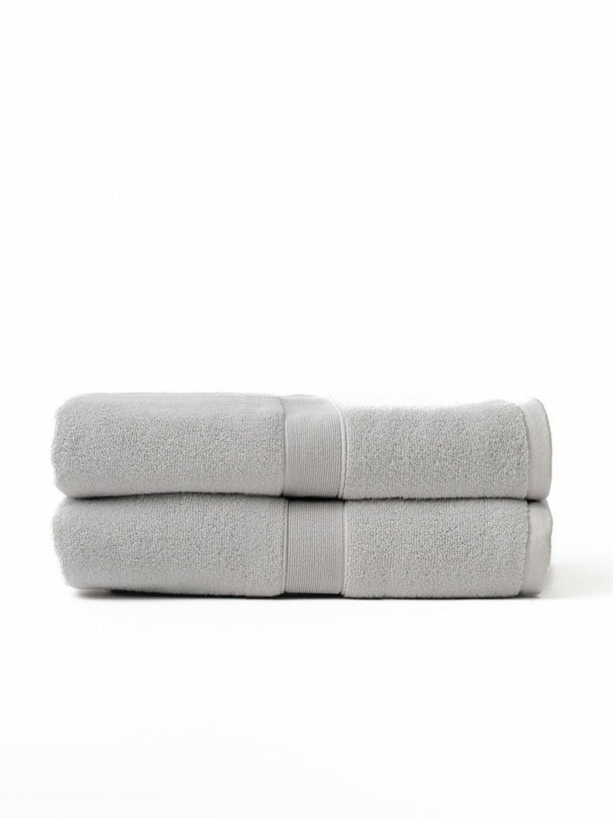 Two light gray bath sheets folded and stacked on a white background, with their woven border bands aligned near the right side.