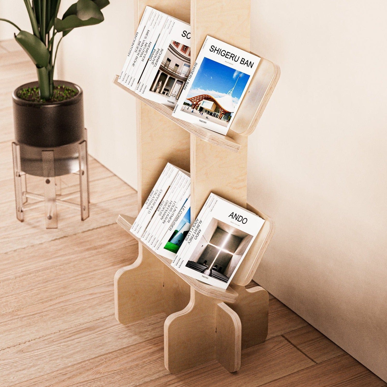 Close angled view of magazines displayed on the lower shelves of the Yankel natural wood bookcase beside a potted plant