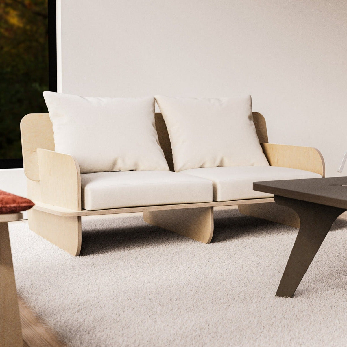 Franklin two-seat low seater with white cushions facing a dark coffee table on a pale textured rug