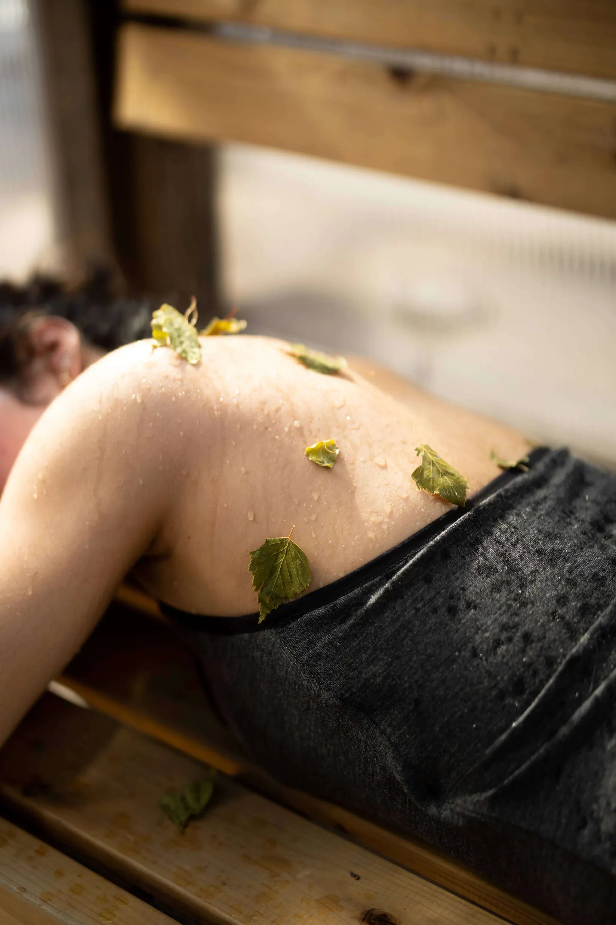 Merino wool sauna bath suit worn during a wellness recovery ritual, highlighting natural comfort and temperature regulation.