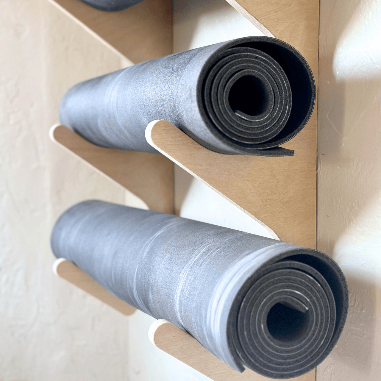 Close-up of wooden hooks on yoga wall storage rack