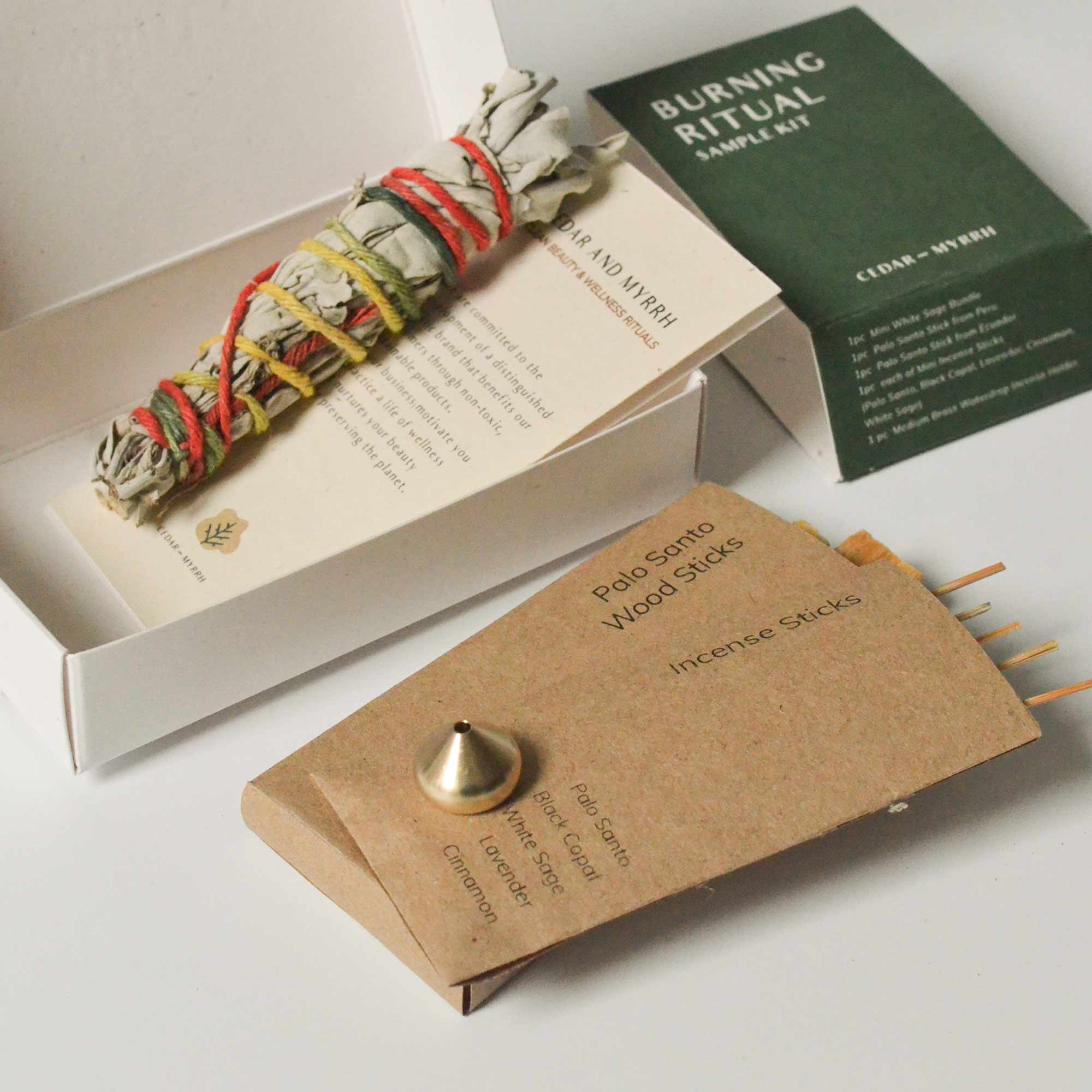 Burning Ritual sample kit with sage bundle, incense sticks, and packaging on a white surface.