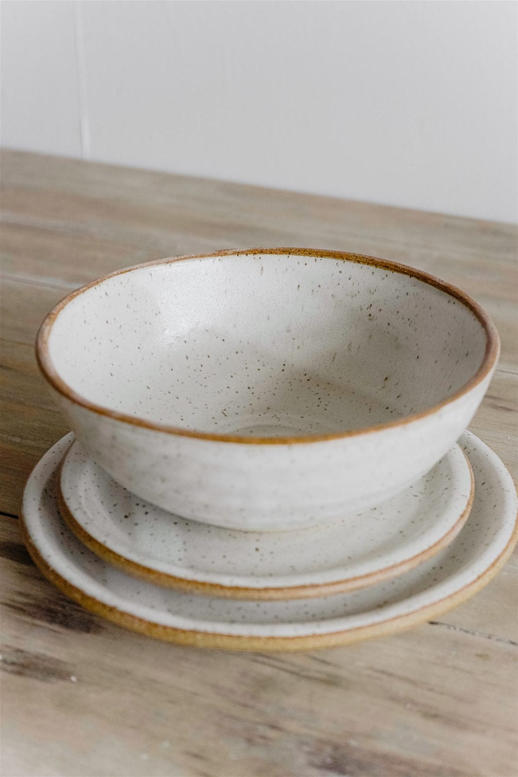 Handmade ramen bowl stacked with Japandi dinnerware plates by KJ Pottery
