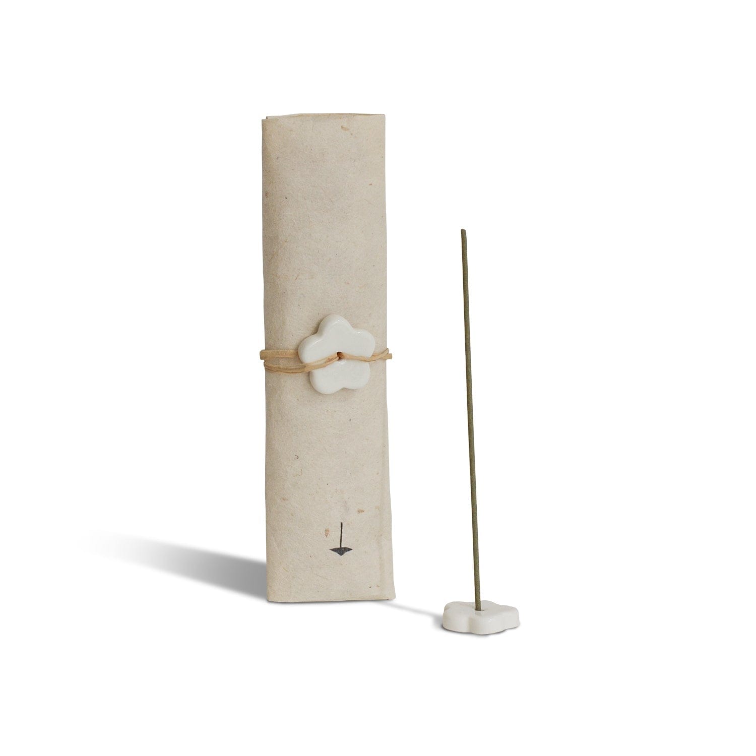 Incense stick holder with a cylindrical beige container and a white flower-shaped incense holder on a white background.