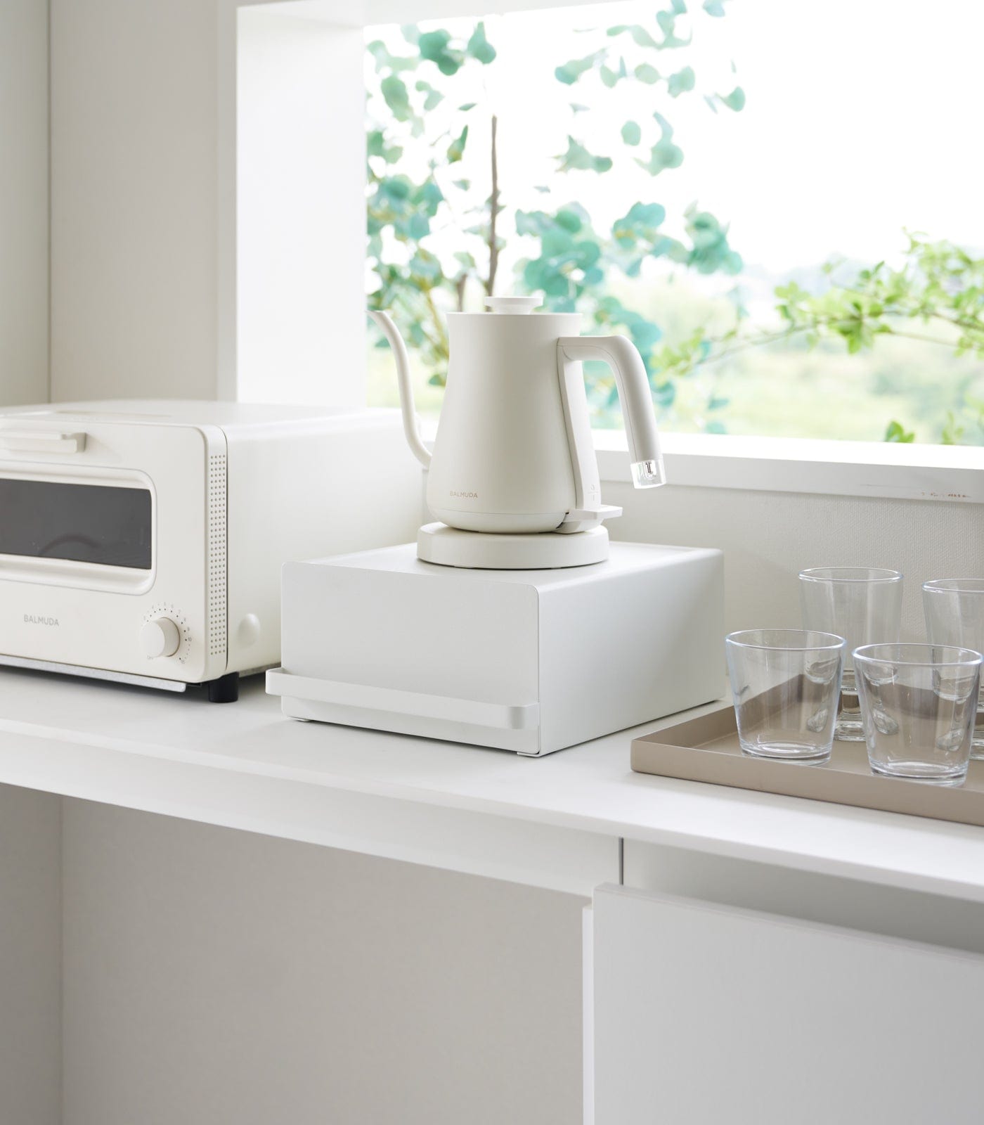 Japandi countertop rack with drawer holding kettle and kitchen essentials