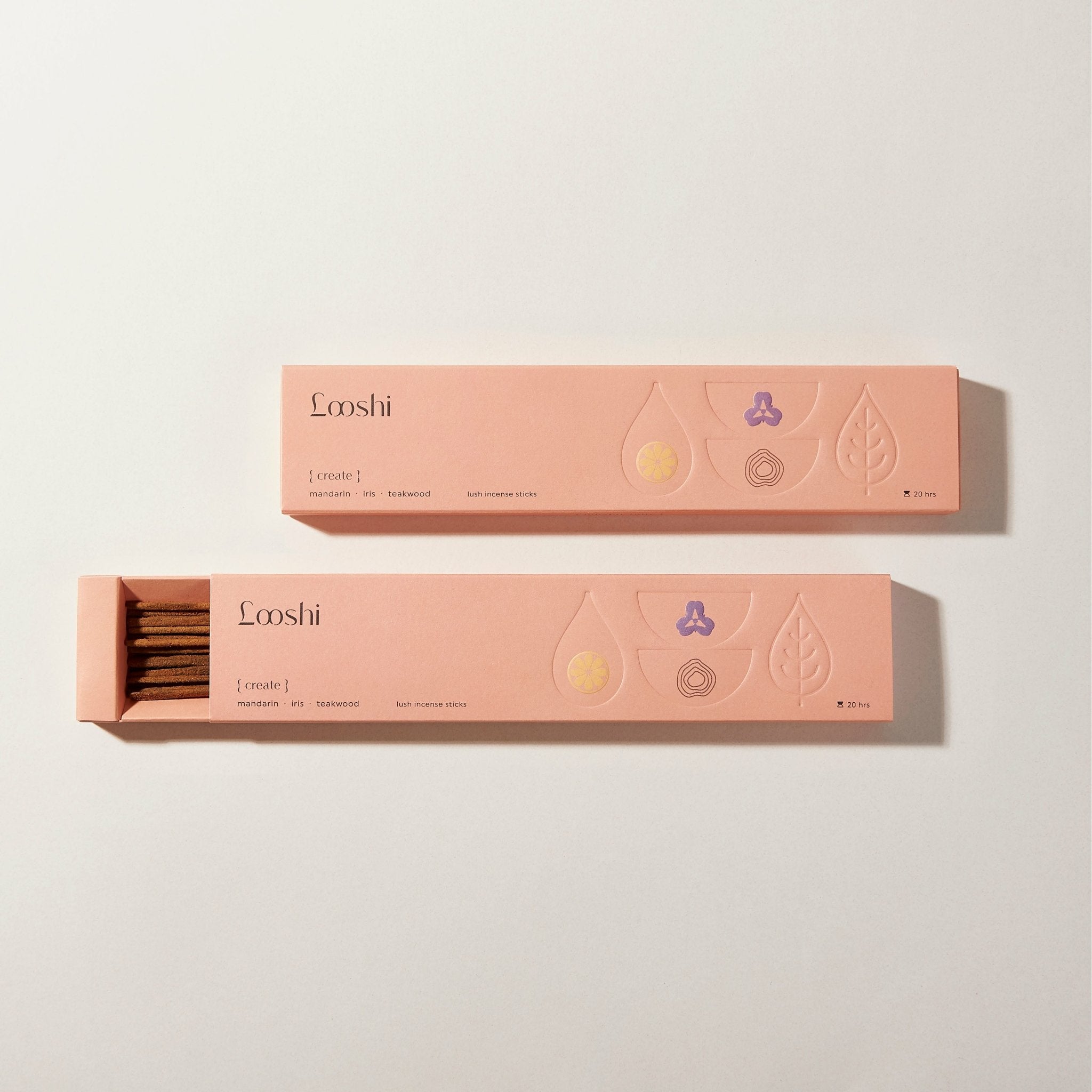 Open and closed peach-colored boxes of Looshi Create incense sticks displayed on a cream background