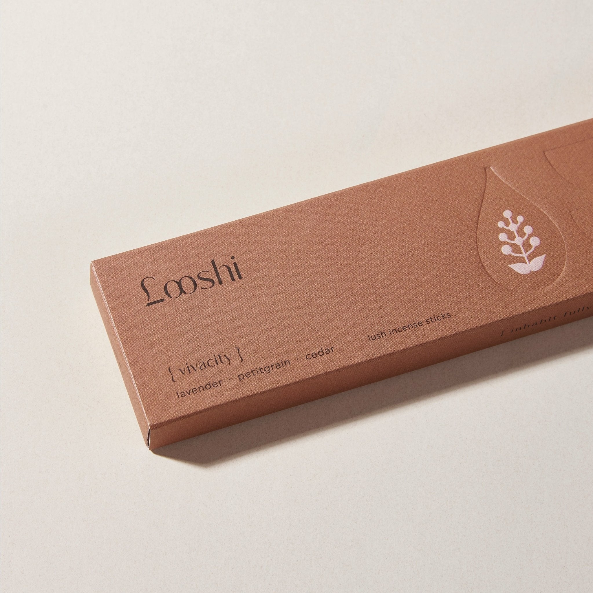 Warm brown box of Looshi Vivacity incense sticks on a cream surface, featuring lavender, petitgrain and cedar fragrances