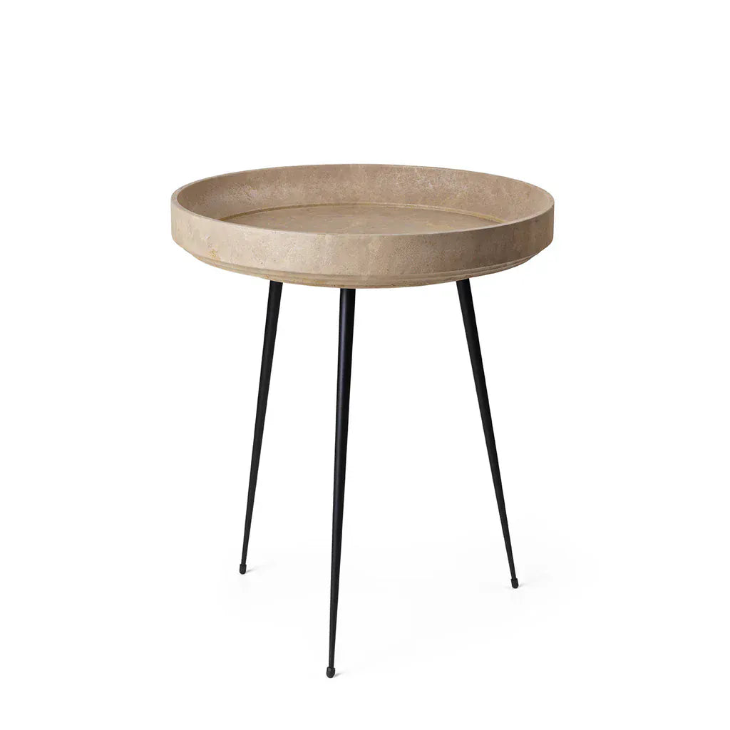 Round side table with a Matek® and black metal legs on a white background