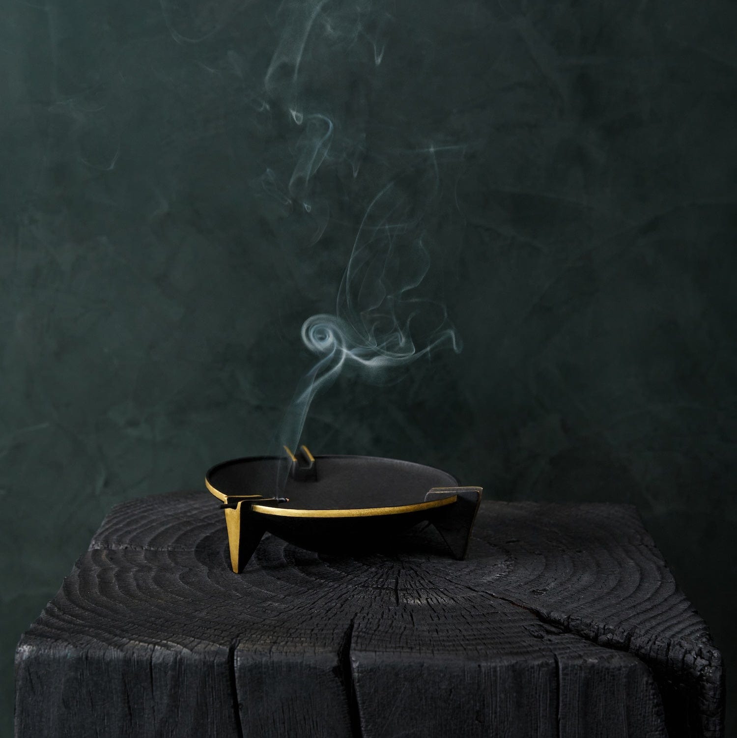Milan ashtray with brass rim holding incense smoke