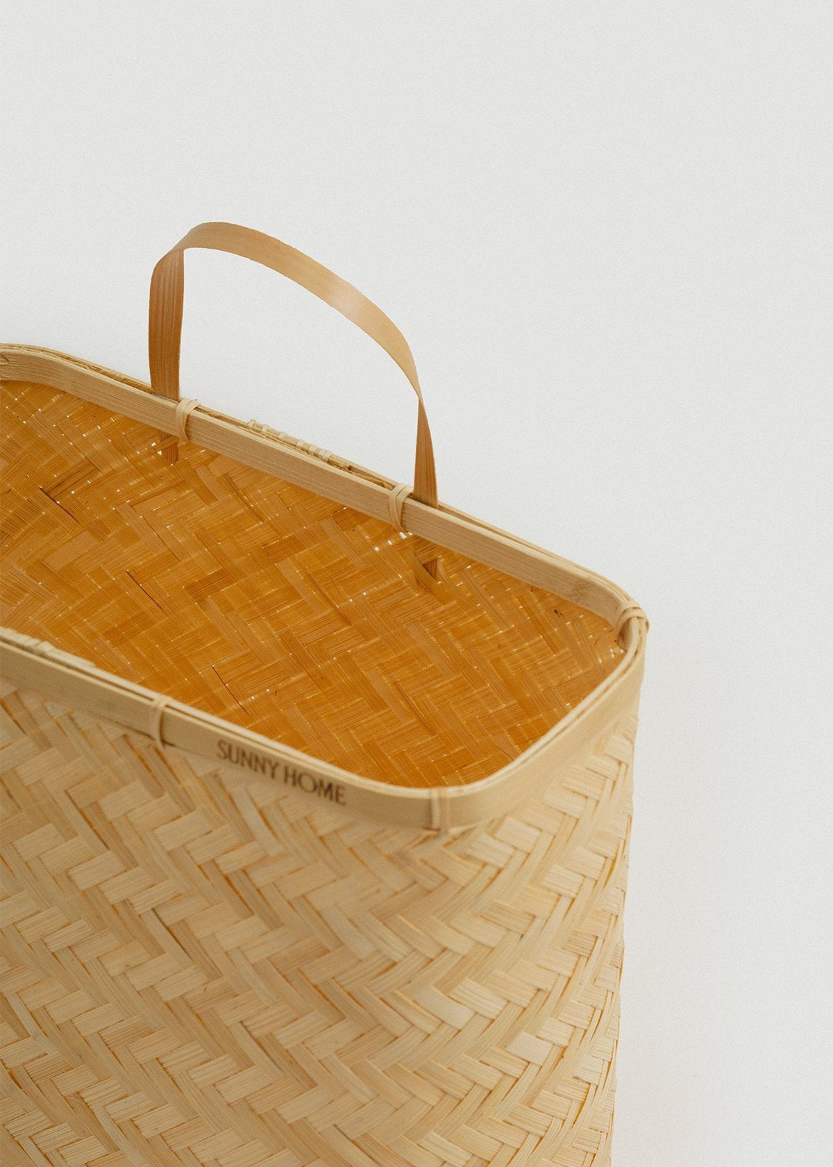Close-up of the reinforced bamboo rim, woven interior, and flexible loop handle.