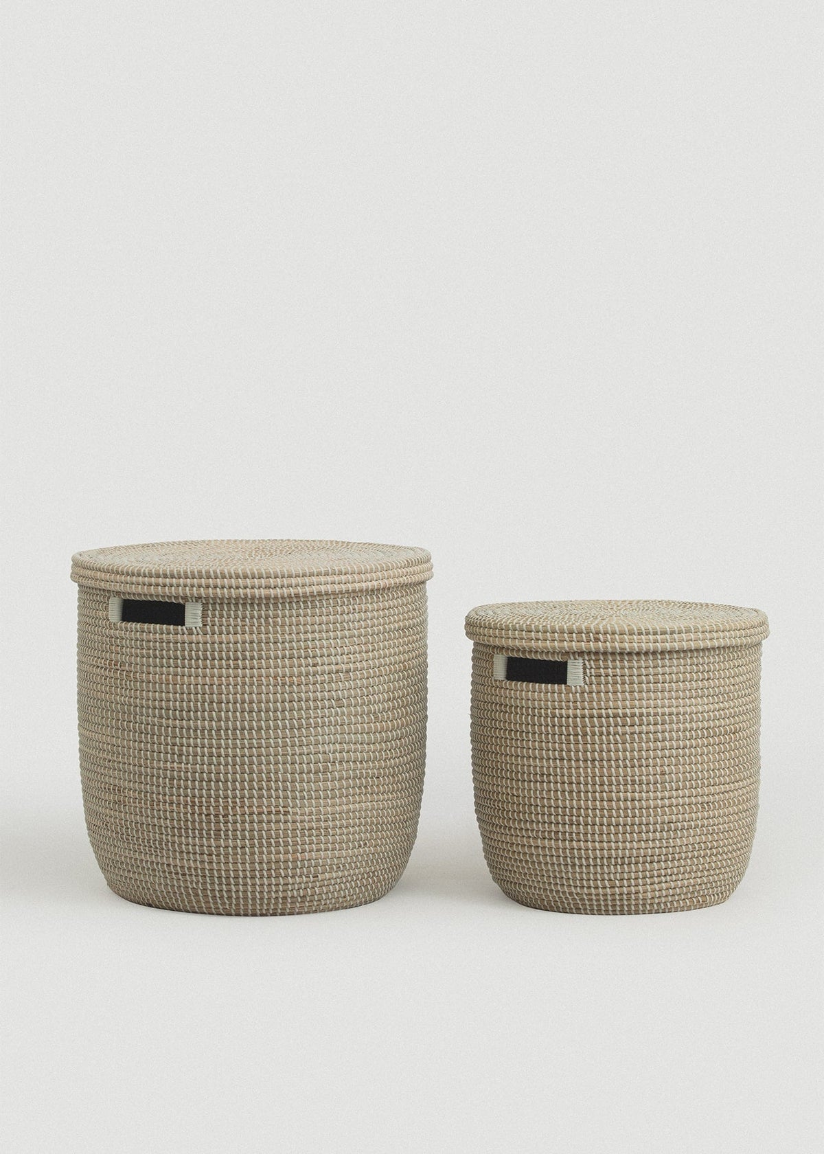Large and small Medina seagrass baskets displayed together with their lids in place.