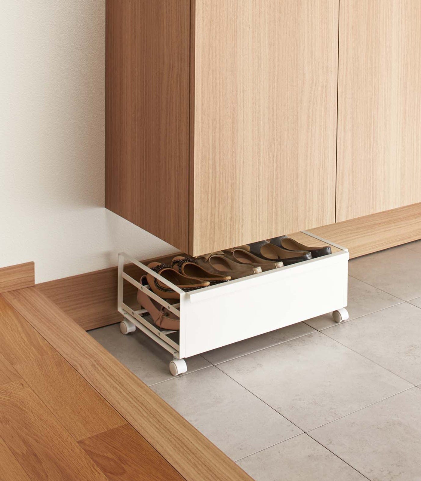 Rolling steel shoe rack under entryway bench