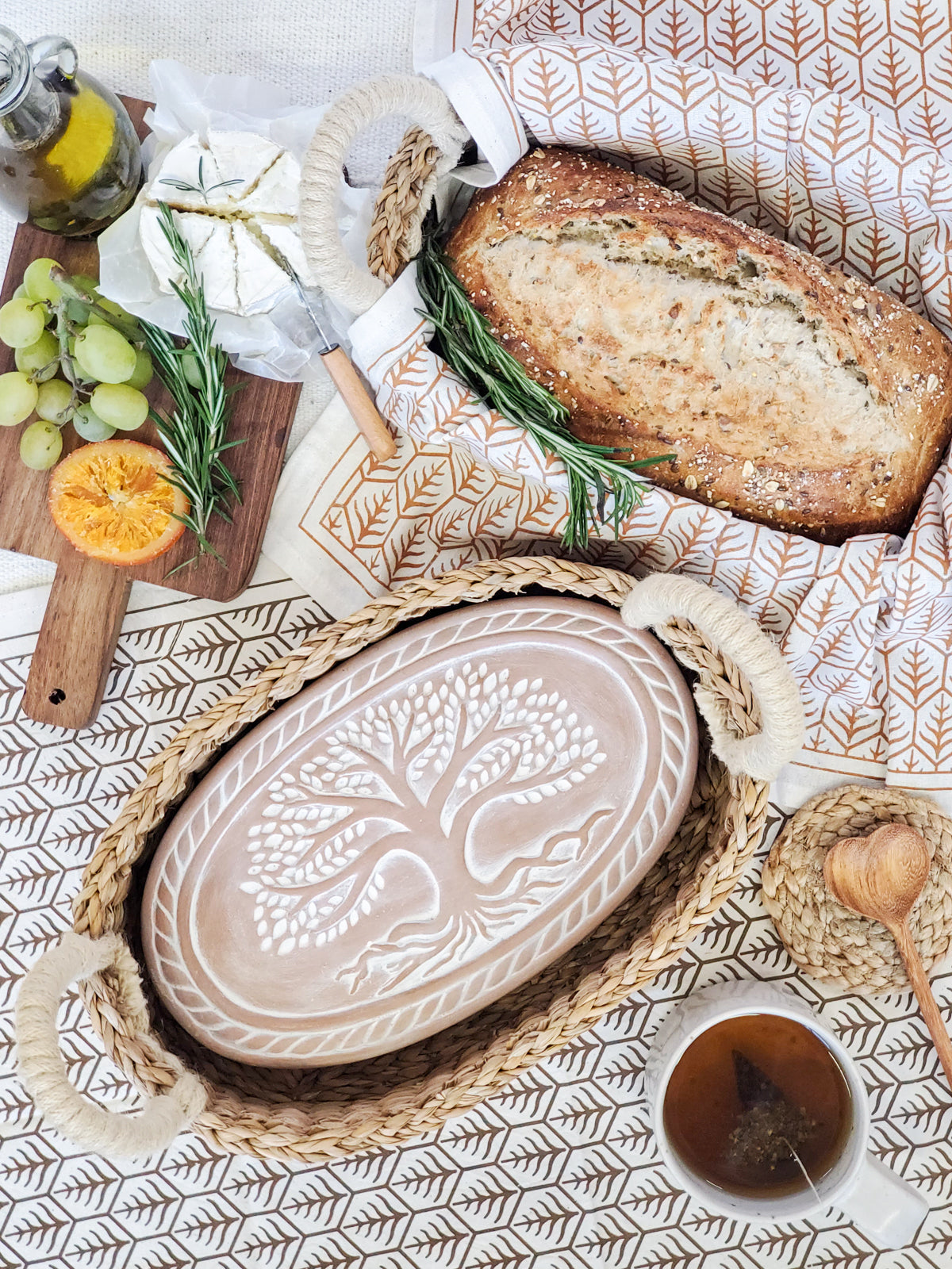 Korissa Bread Warmer Basket Gift Set styled with bread, lemon, and spices