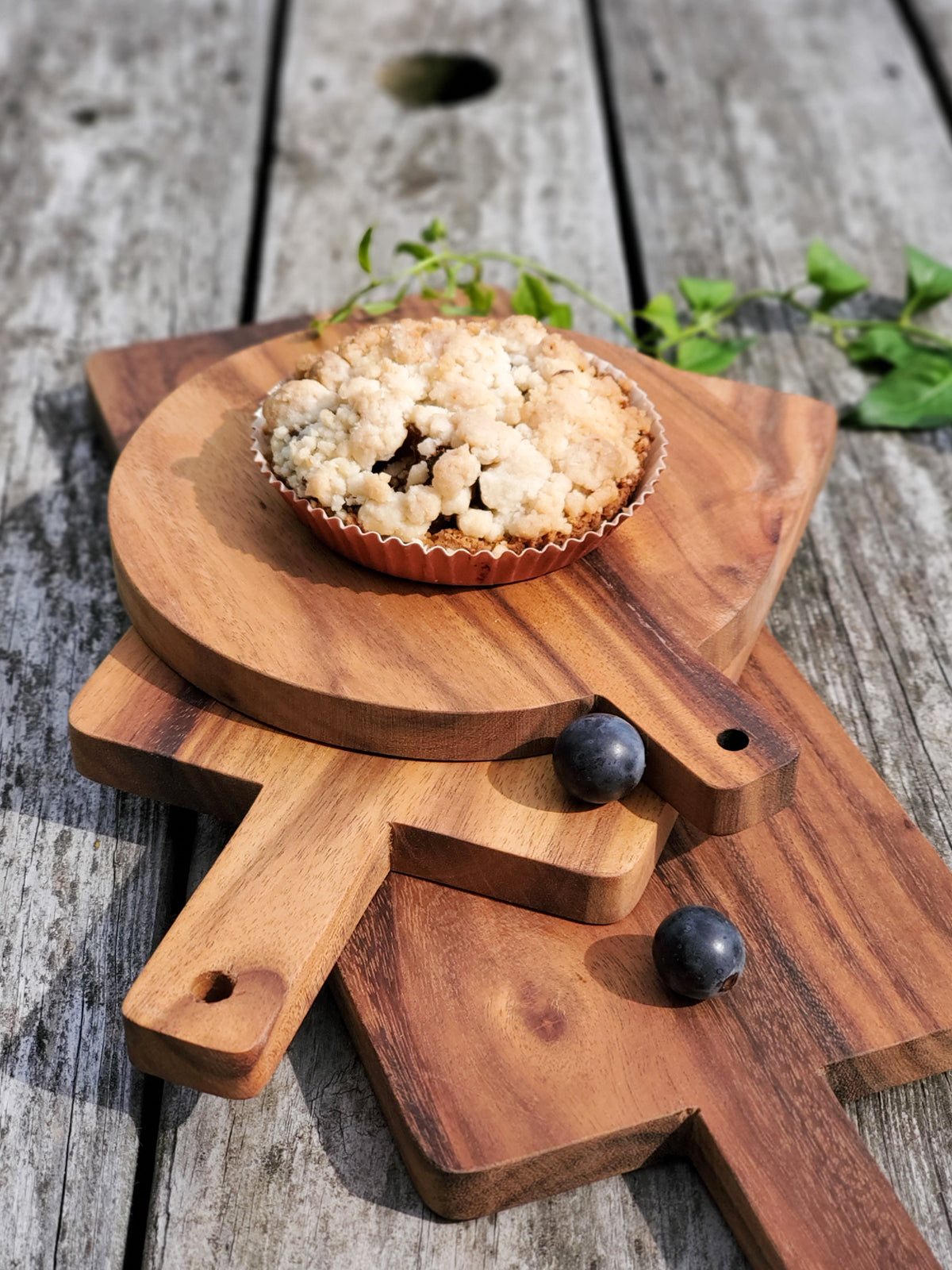 Korissa Wooden Round Serving Board with tart, blueberries, and greenery styled