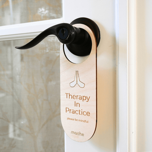 Door handle with a 'Therapy In Practice' sign on a door