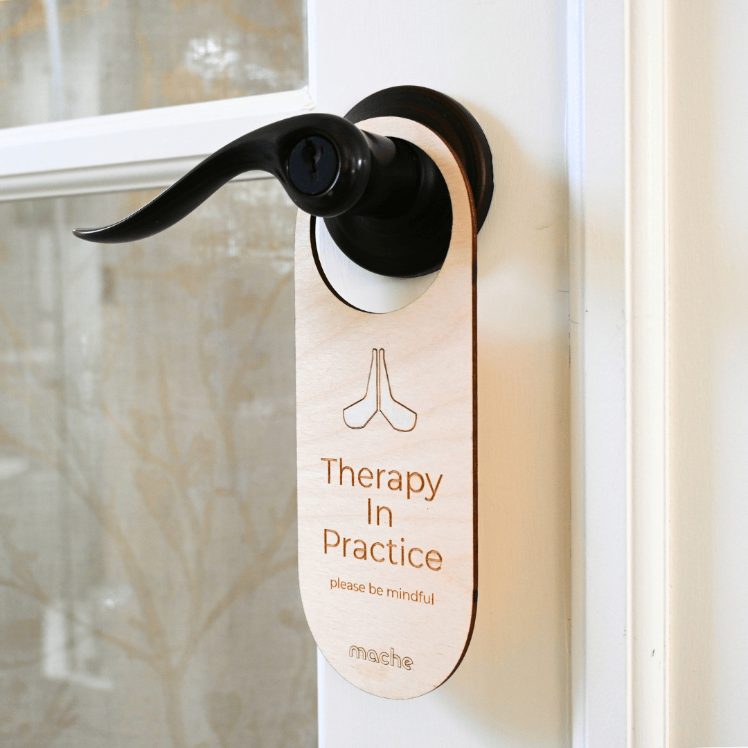 Door handle with a 'Therapy In Practice' sign on a door