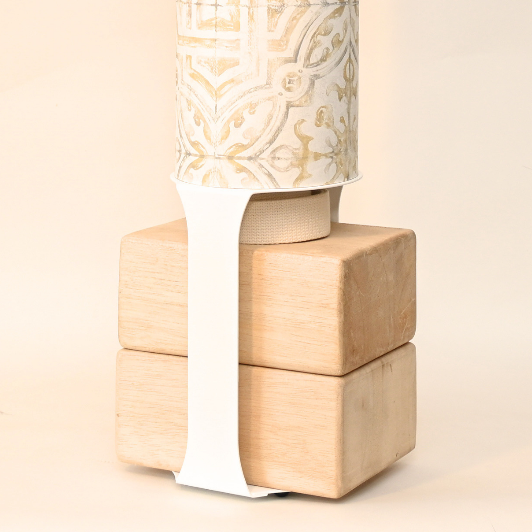 Close-up of the wooden block base secured with a contrasting white strap.