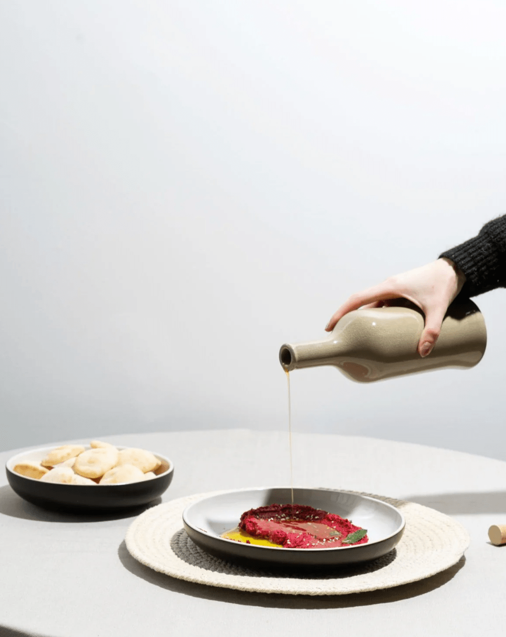 Stoneware Olive Oil Dispenser - Brutto 21 oz in Linen in use