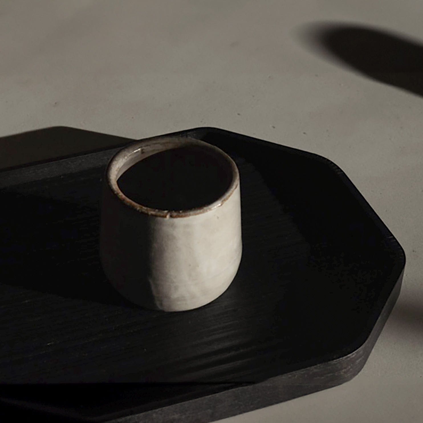 Versatile Sand Ceramic Cup On Black Tray
