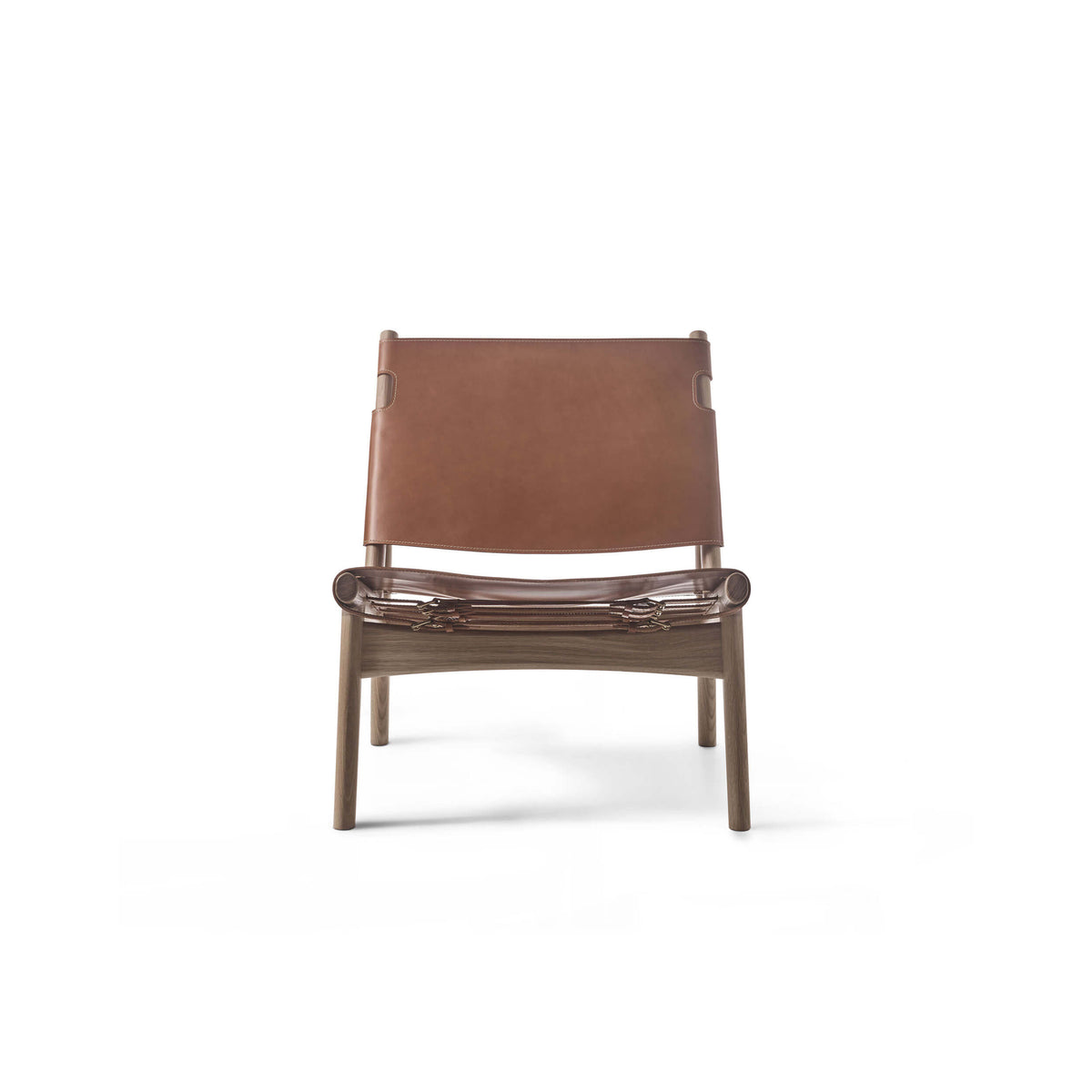 Front view of the tan leather Eikund Hunter Lounge Chair against white, showing its rectangular sling back, suspended seat, visible metal fittings, and tapered wood legs.