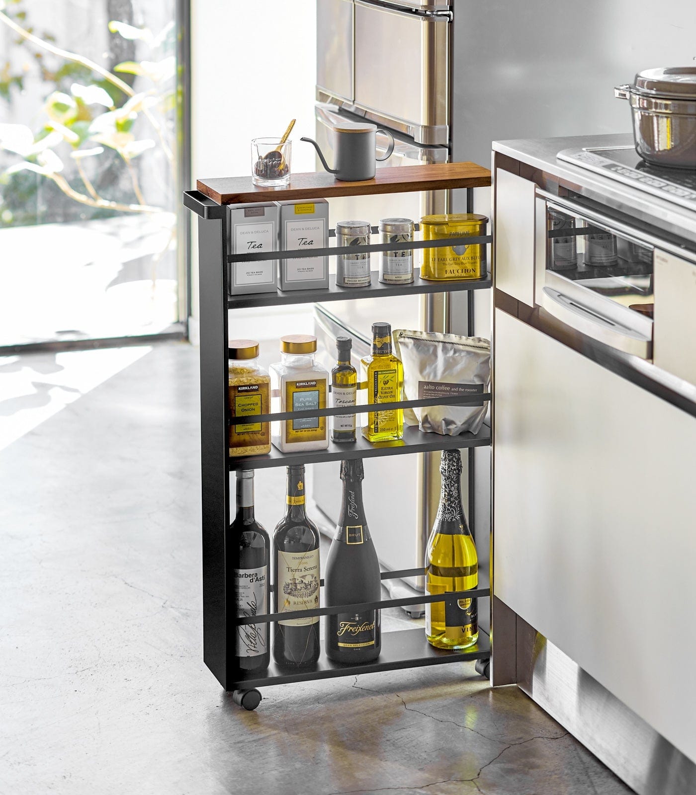 Kitchen cart with bottles and containers in a modern kitchen setting. Slim Storage Cart (32" H)  - Steel