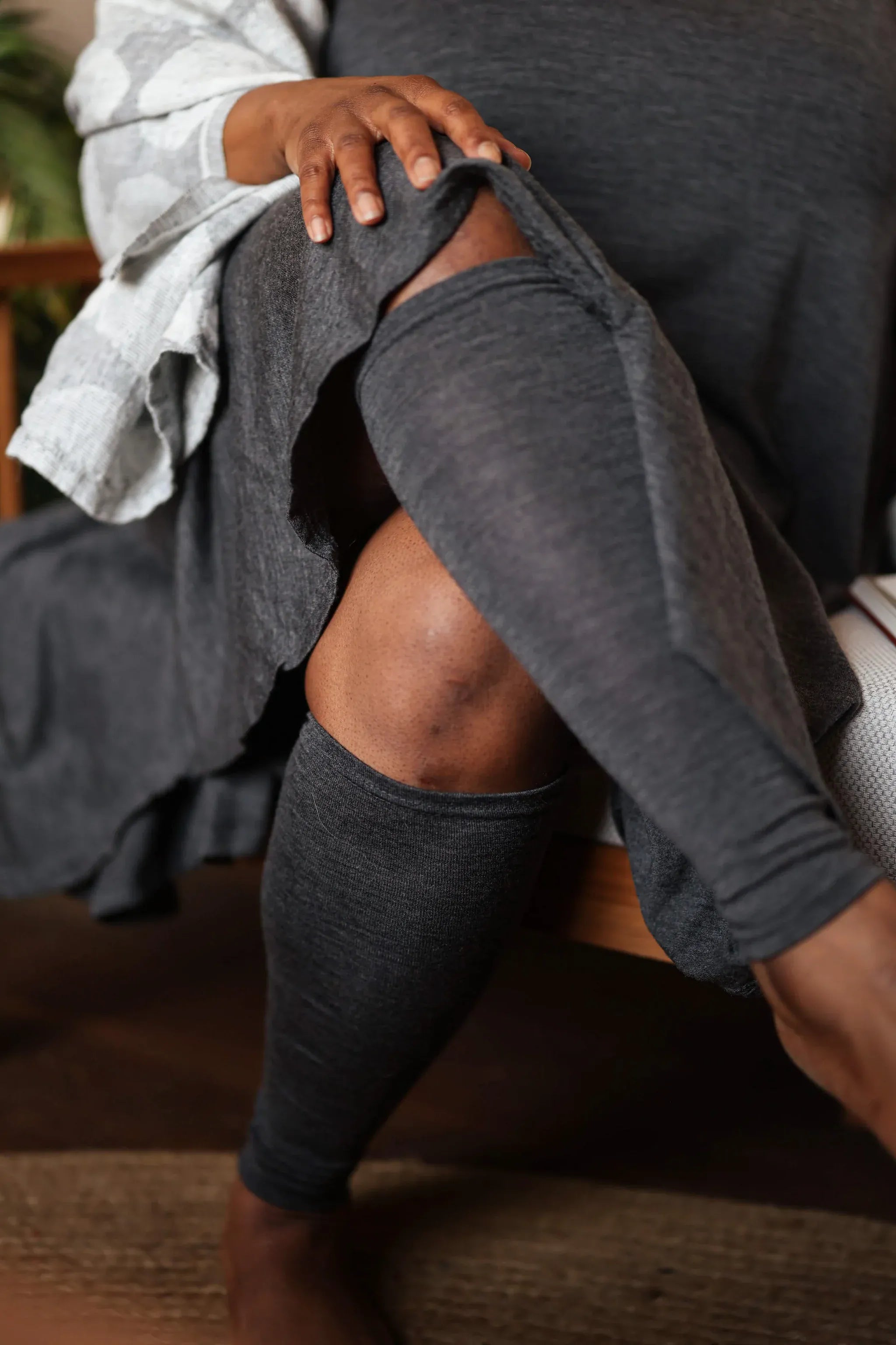 Woman wearing merino wool leg warmers showcasing soft natural wool comfort and flexible everyday styling.