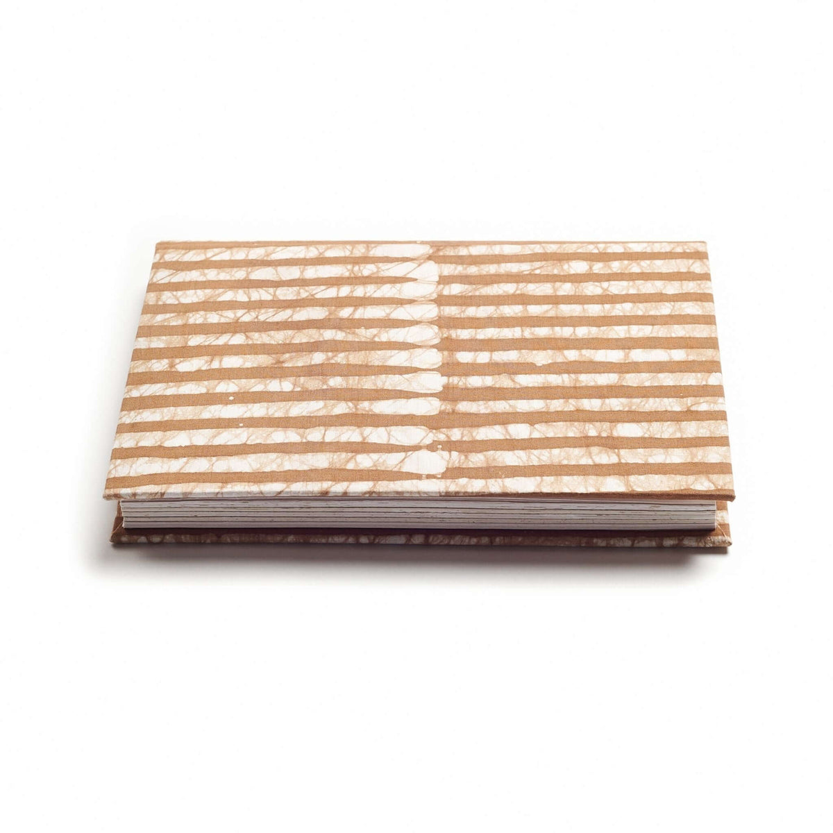 Low side view of the closed Oak Brown journal showing its striped cover, layered handmade pages and dark binding