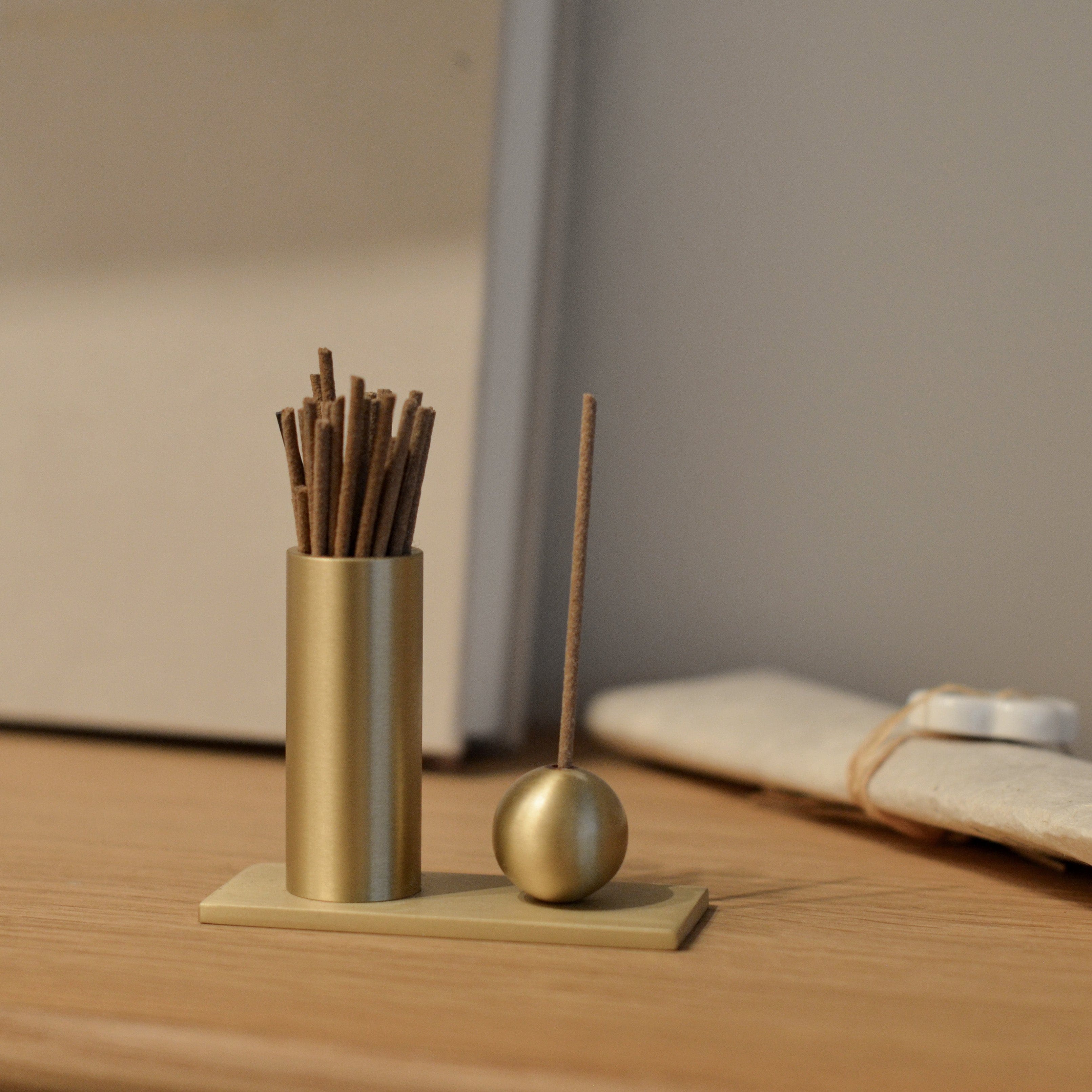 Cylinder & Sphere Brass Incense Holder on Desk