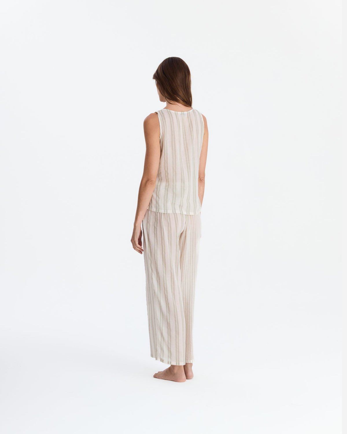 Back view of the pajama set, showing the top’s straight neckline, vertical back stripes, and matching loose-fitting pants.