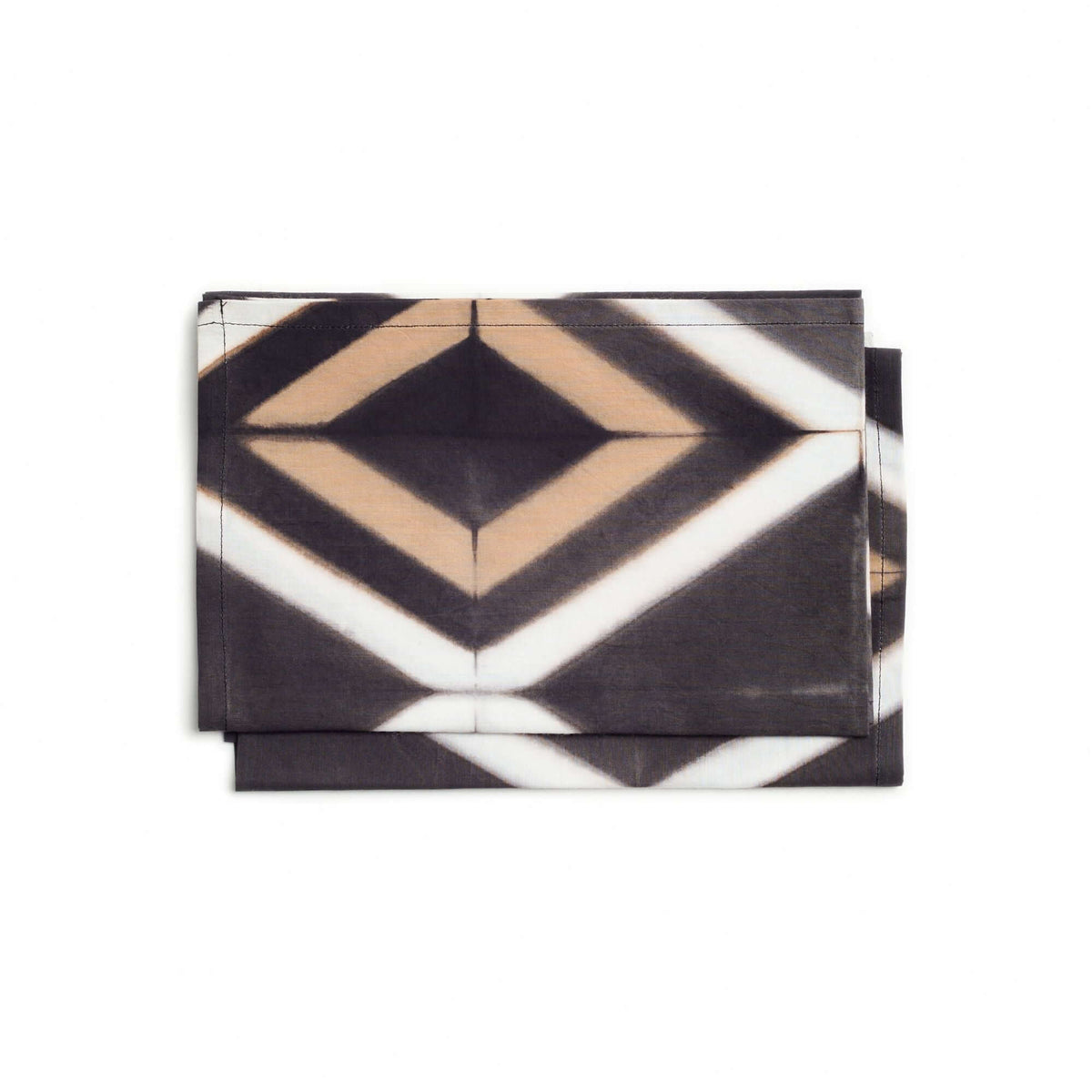 Folded stack of Tisa napkins showing the bold black, cream, and tan diamond pattern.