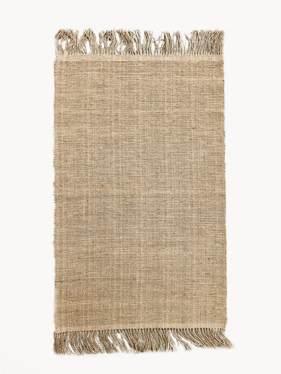 Korissa Goldilocks Rug, natural braided jute, fringe edges, white background