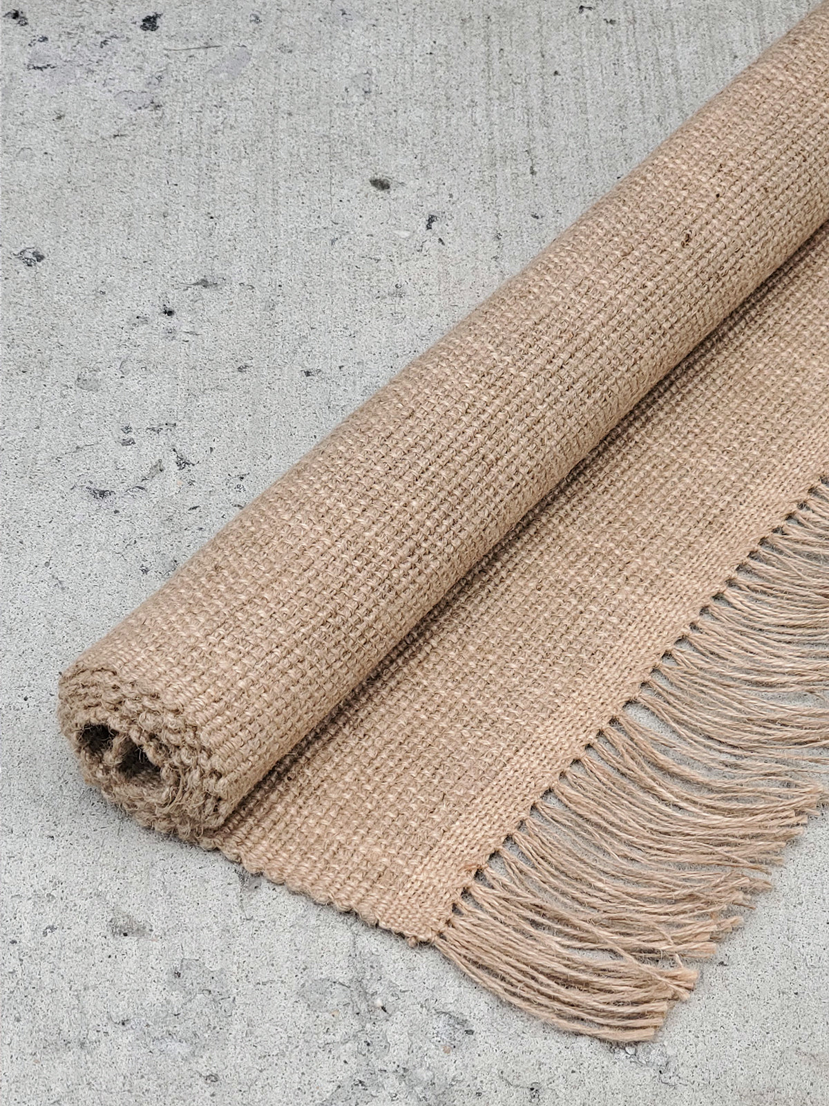 Korissa Goldilocks Rug, natural colorway, rolled, alternate angle