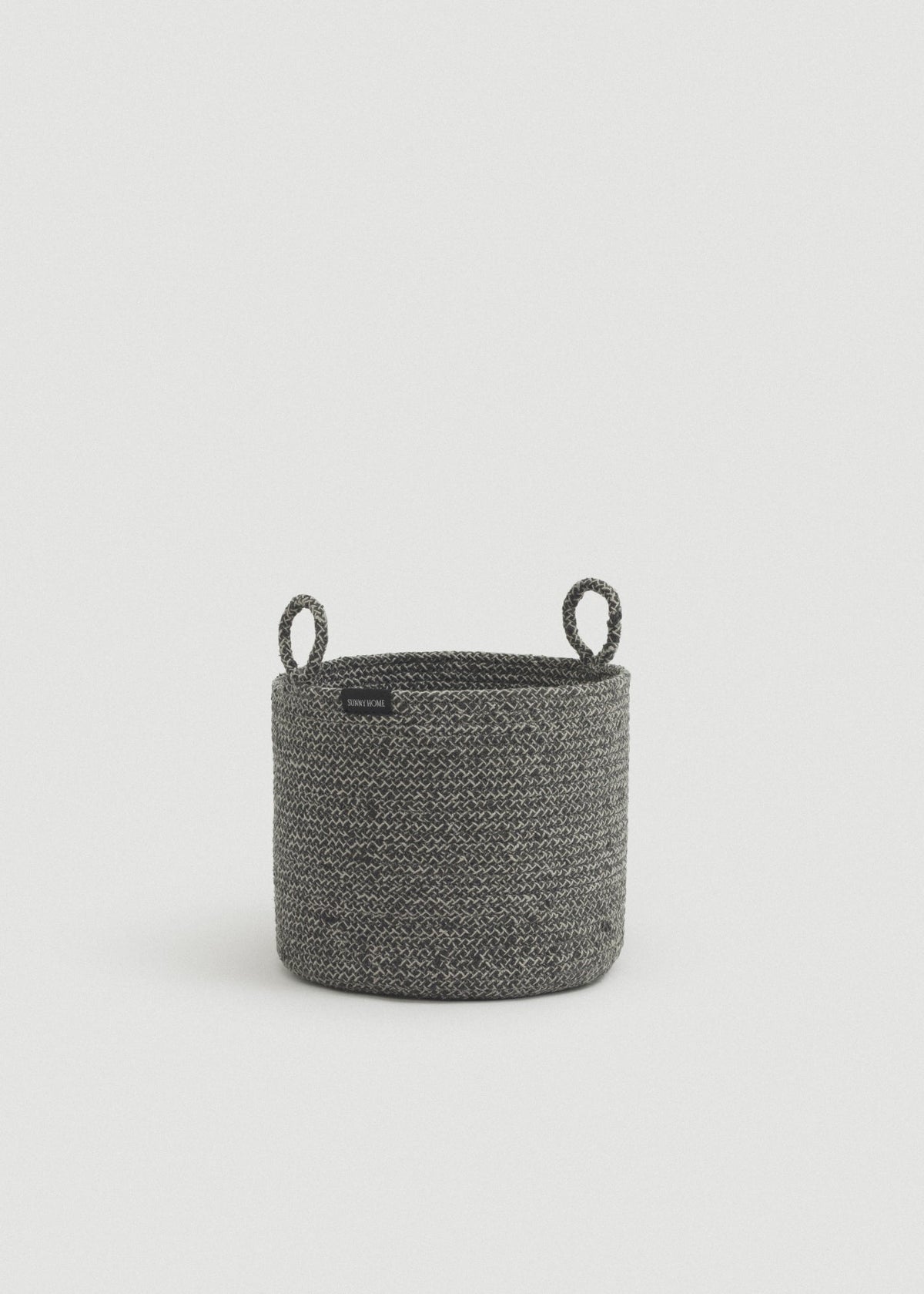 Gray melange cotton rope storage basket with a cylindrical shape and two upright loop handles.
