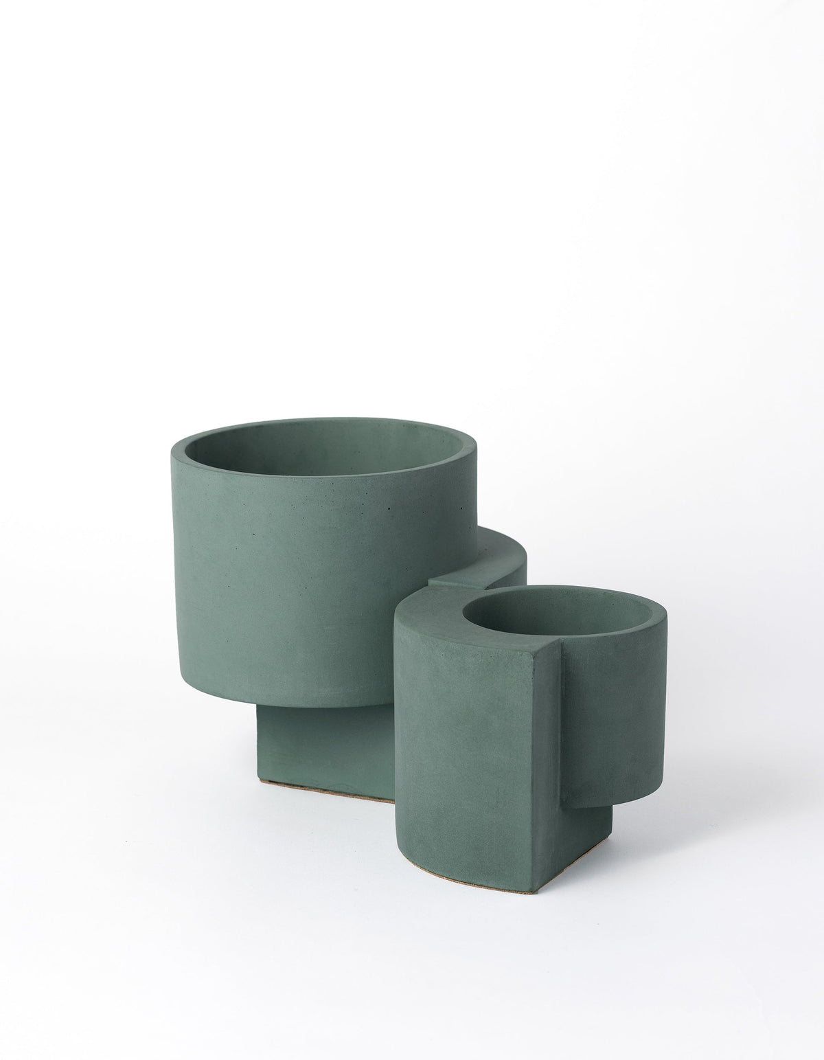 Dark blue-green Tortuga Forma Platform Planter Set viewed at an angle on white, showing two empty cylindrical pots with smooth surfaces and offset vertical supports.
