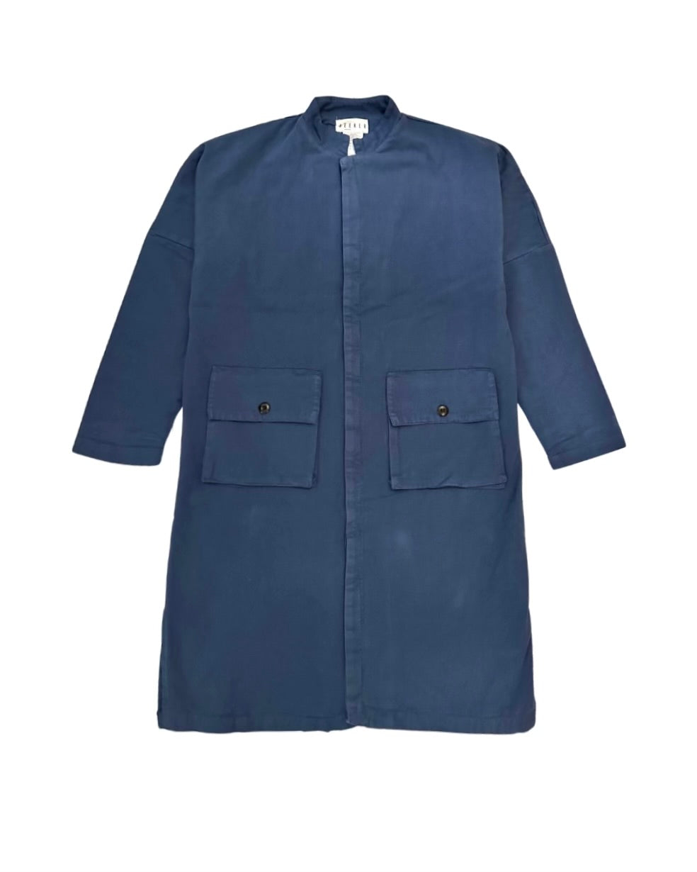 Front product view of the muted blue Passage Jacket with a band collar and flap pockets.