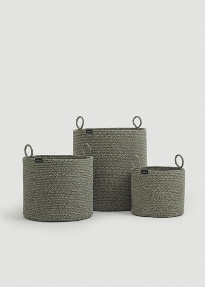 Three cotton rope baskets in graduated sizes arranged together.