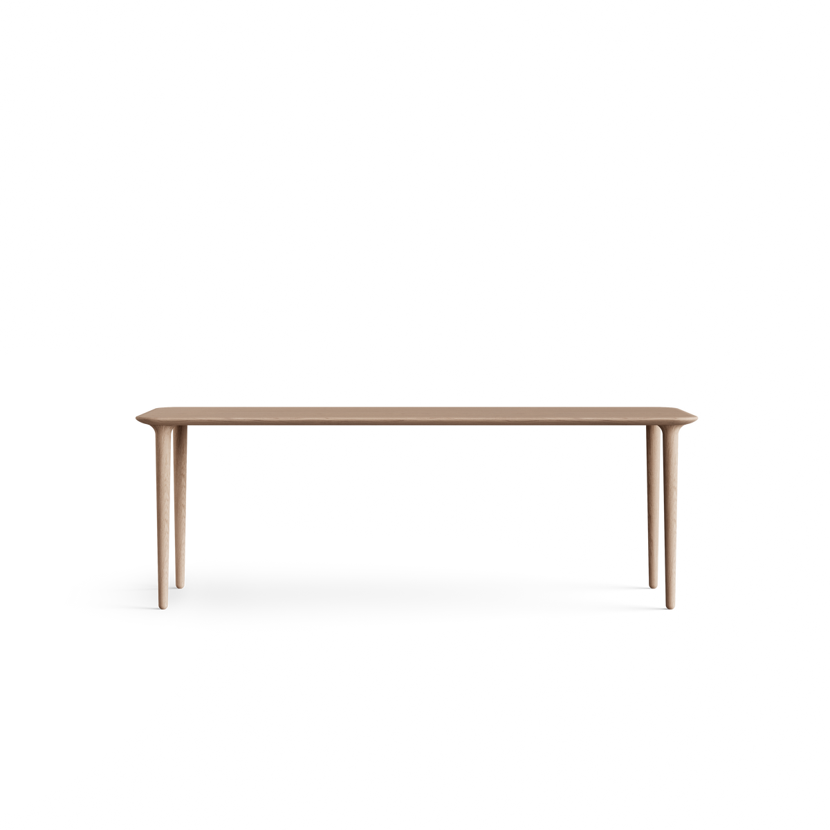 Low long-side view of the light wood Eikund Evja Rectangle Coffee Table, showing its thin tabletop profile, softly rounded ends, and tapered legs positioned near the corners.