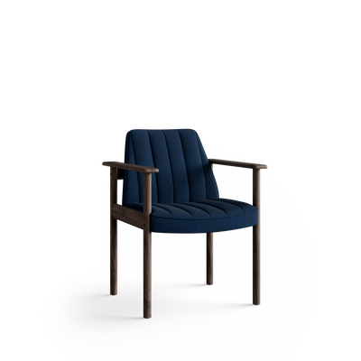 Three-quarter front view of the blue Eikund Ry Arm Chair, showing its sloping channel-stitched back, curved padded seat edge, and open wood arm supports.
