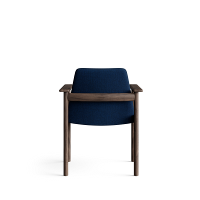 Rear view of the blue Eikund Ry Arm Chair, showing a smooth upholstered back crossed by a horizontal dark wood rail beneath the armrests.