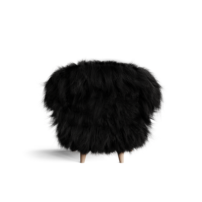 Rear view of the Eikund Fluffy Lounge Chair, showing black shaggy upholstery covering its wide curved back, with two light wood legs visible below.