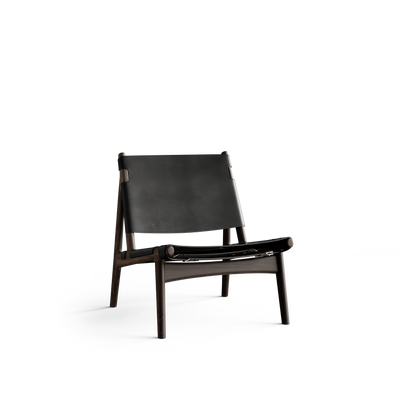 Three-quarter front view of the Eikund Hunter Lounge Chair with a dark wood frame and black leather sling seat and back, showing its reclined backrest, open sides, splayed legs, and metal fittings beneath the seat.