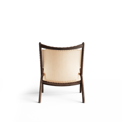 Rear view of the Eikund Krysset Lounge Chair, showing pale tan leather stretched between dark wood uprights and secured with lacing along the sides and lower edge.