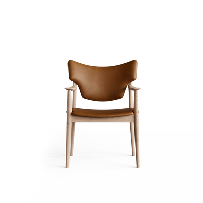 Front view of the cognac-brown Eikund Veng Arm Chair, showing raised backrest corners, gently curved wood armrests, and a slim seat above the exposed wood rail.