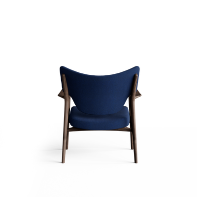 Rear view of the blue Eikund Veng Lounge Chair, showing its curved upholstered back with raised outer corners, exposed dark wood uprights, and slim legs.