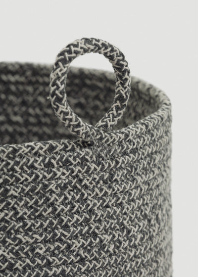 Close-up of the gray-and-cream braided rope, rounded rim, and circular loop handle.