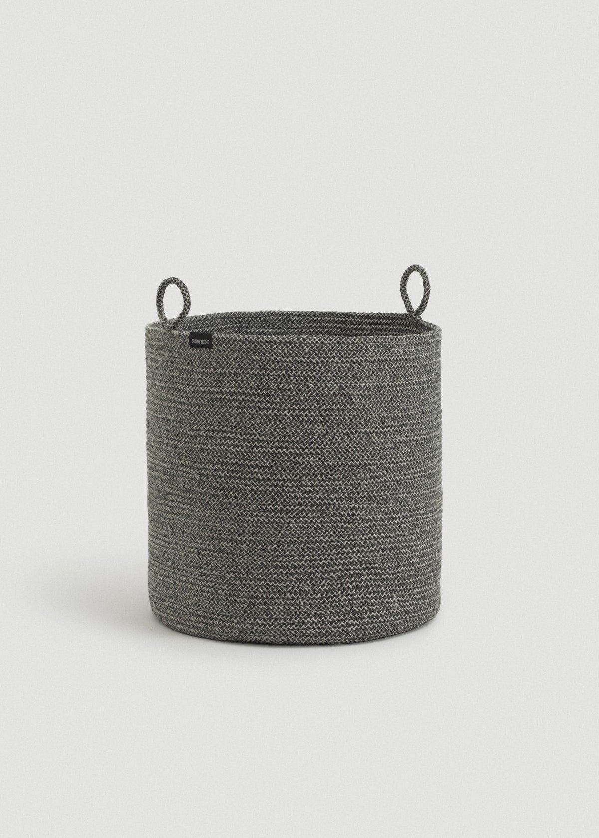 Tall gray rope basket displayed alone against a light neutral background.