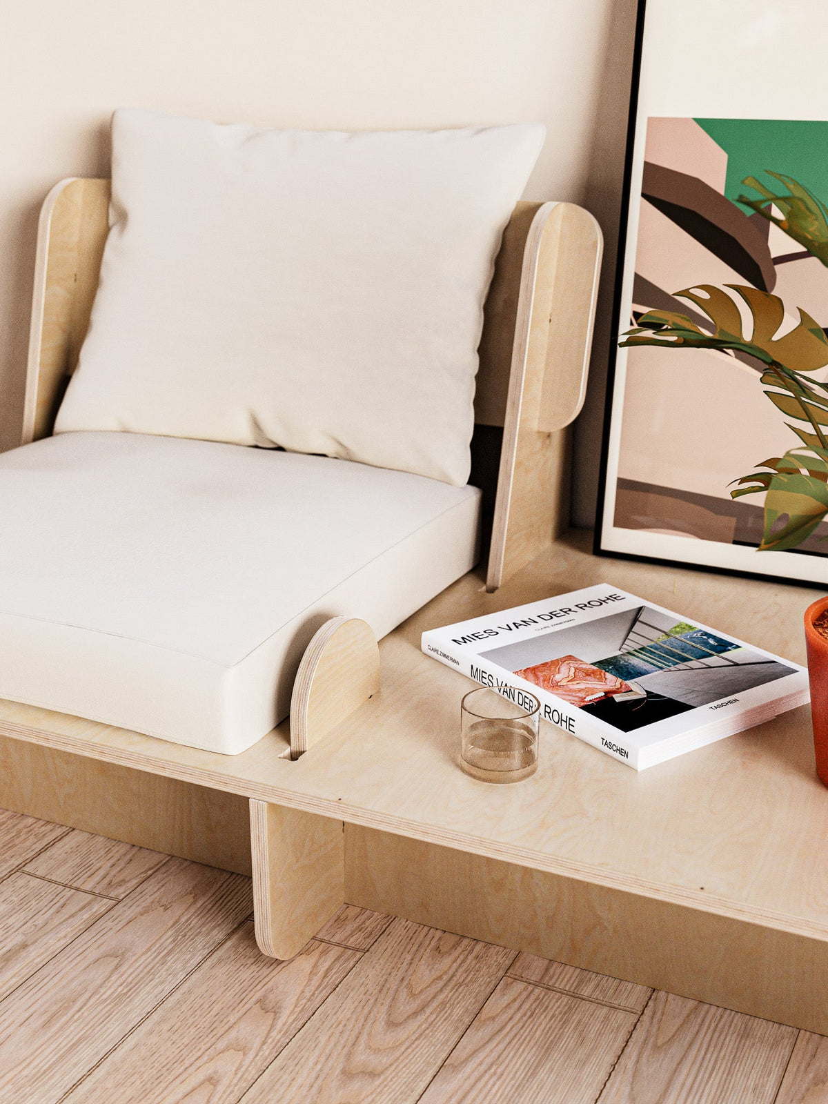 Franklin single low seater with white cushions and an integrated side platform styled with books and glassware