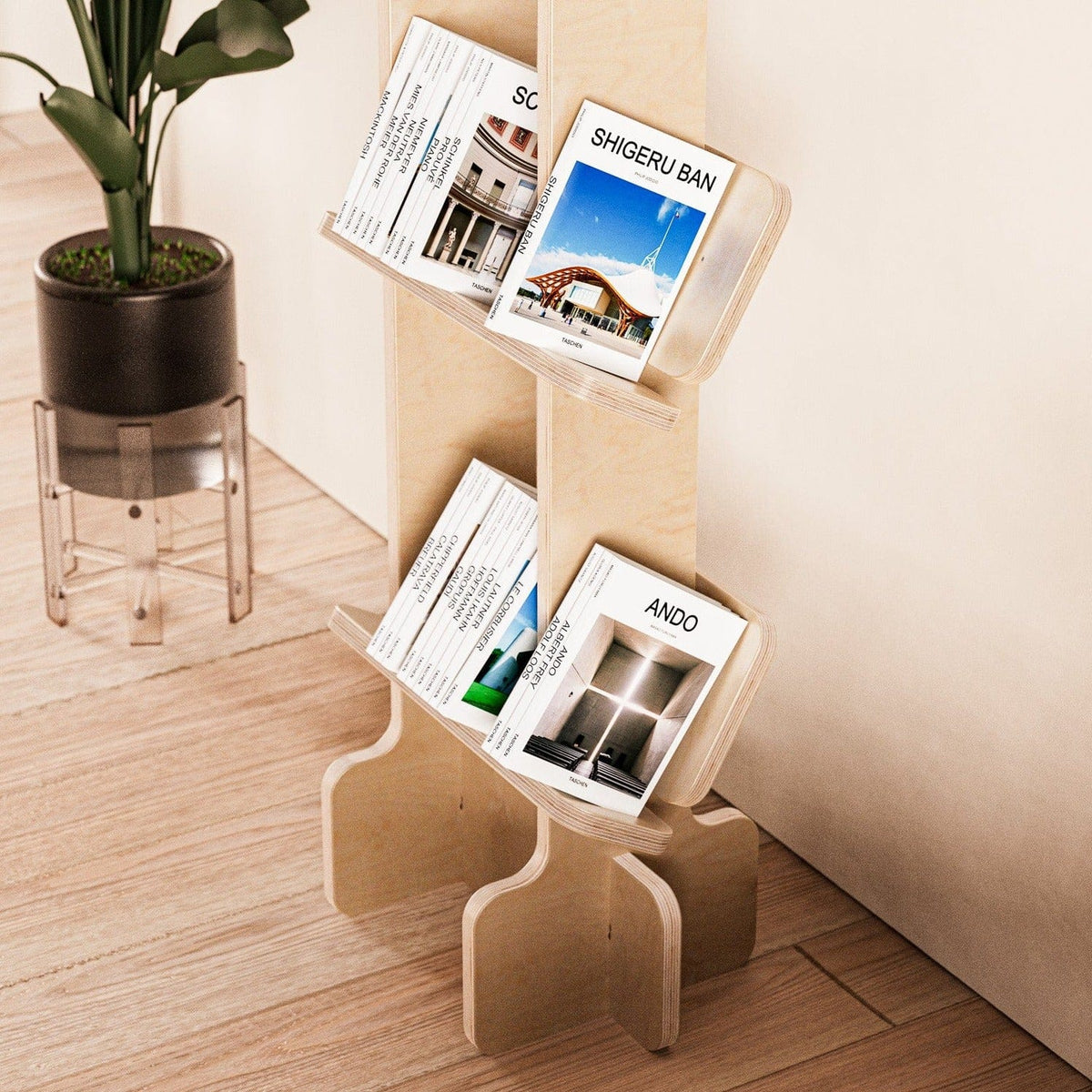 Close angled view of magazines displayed on the lower shelves of the Yankel natural wood bookcase beside a potted plant